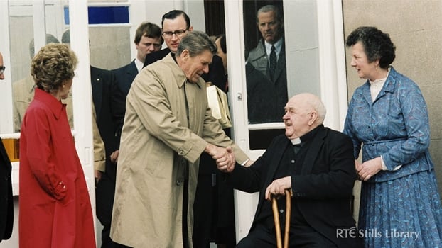 President Reagan shakes hands with Father John Murphy