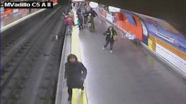 Passengers take action as woman lies unconscious on rail track Passengers take action as woman lies unconscious on rail track