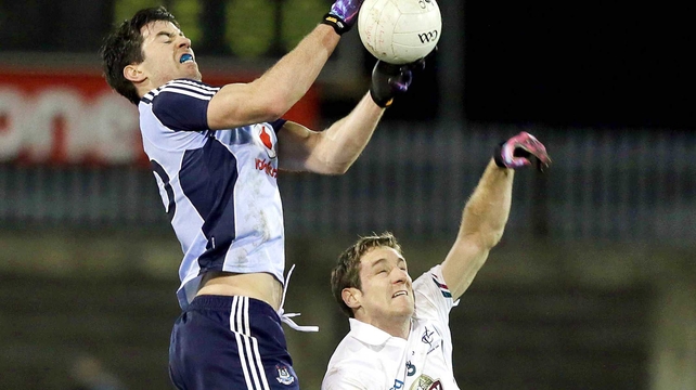 Dublin's Michael Daragh MacAuley with Gary White of Kildare