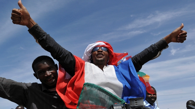 Youths celebrate with the French flag in Ansongo, a town south of the northern Malian city of Gao, as Niger troops enter the city Youths celebrate with the French flag in Ansongo, a town south of the northern Malian city of Gao, as Niger troops enter the city