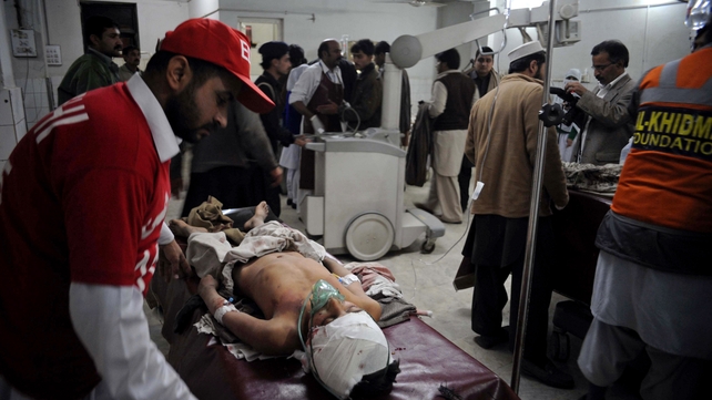 Pakistani paramedics treat injured bomb blast victims at a hospital intensive care unit in Peshawar following a separate blast Pakistani paramedics treat injured bomb blast victims at a hospital intensive care unit in Peshawar following a separate blast