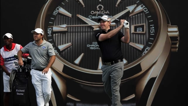 Stephen Gallacher watches his tee shot, while Richard Sterne clocks where the ball lands in Dubai