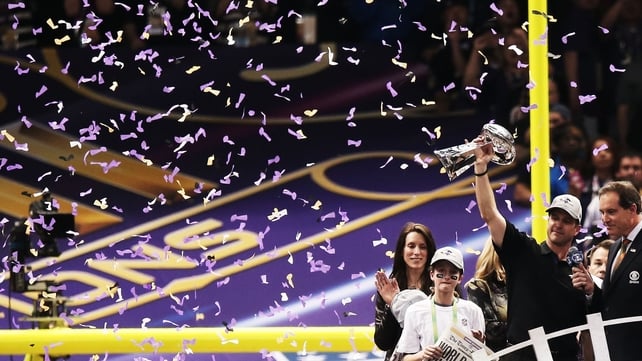 Baltimore head coach John Harbaugh holds the Vince Lombardi trophy aloft