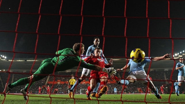 Joe Hart of Manchester City dives in vain as Steven Davis of Southampton scores their second goal