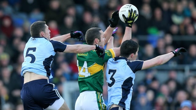 Kerry's Patrick Curtin jumps with Darren Daly and Rory O'Carroll of Dublin