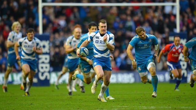Stuart Hogg of Scotland breaks away to score his try against Italy