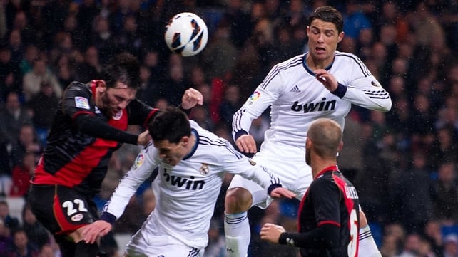 Cristiano Ronaldo goes for the ball with Sueliton Pereira of Rayo Vallecano