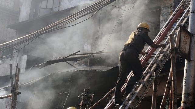 Indian firefighters climb a ladder as they attempt to control a blaze in the Surya Sen market building in Kolkata Indian firefighters climb a ladder as they attempt to control a blaze in the Surya Sen market building in Kolkata