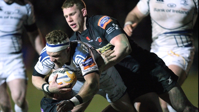 Ian Madigan is tackled by Patrick Leach and Jack Dixon