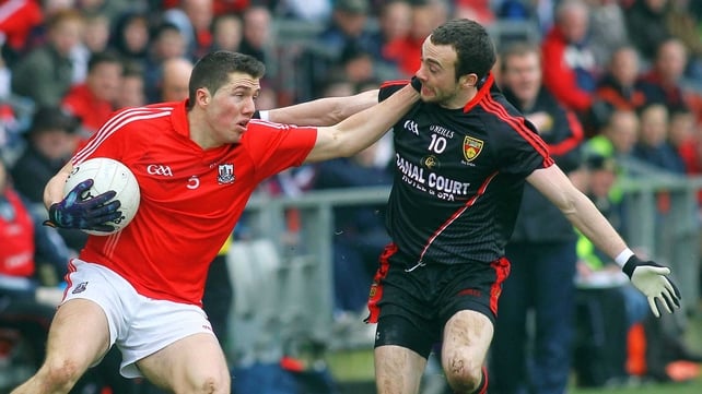 Cork's Thomas Clancy holds off the challenge of Down's Conor Laverty
