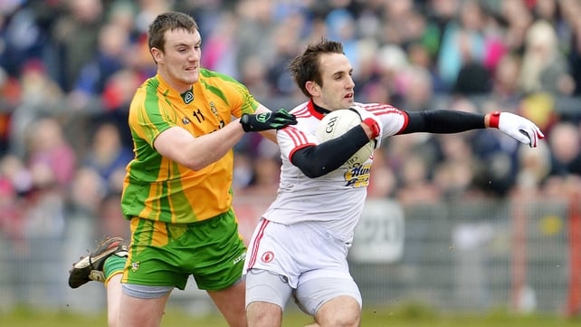 Tyrone's Mark Donnelly tries to escape the clutches of Donegal's Leo McLoone