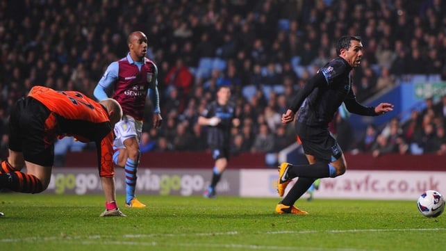 Carlos Tevez rounds Brad Guzan before scoring