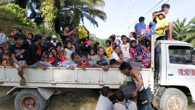 Residents leave their village in Tanjung Labian near Tanduo - close to where the assault was launched Residents leave their village in Tanjung Labian near Tanduo - close to where the assault was launched
