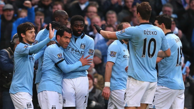 City players congratulate Carlos Tevez after the first of his three goals