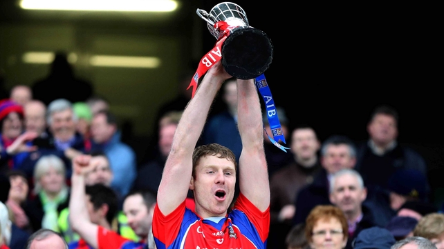 Robert Murray lifts the Tommy Moore Cup for St Thomas's