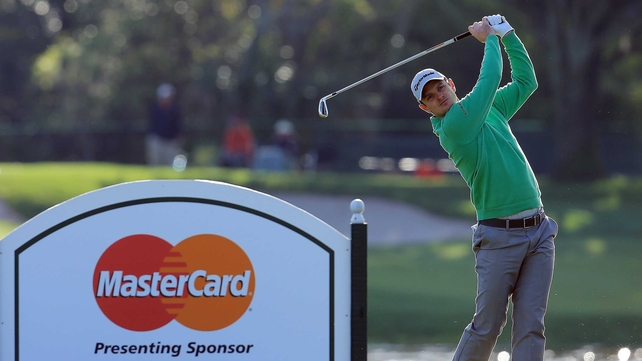Justin Rose plays his tee shot on the par three 14th hole