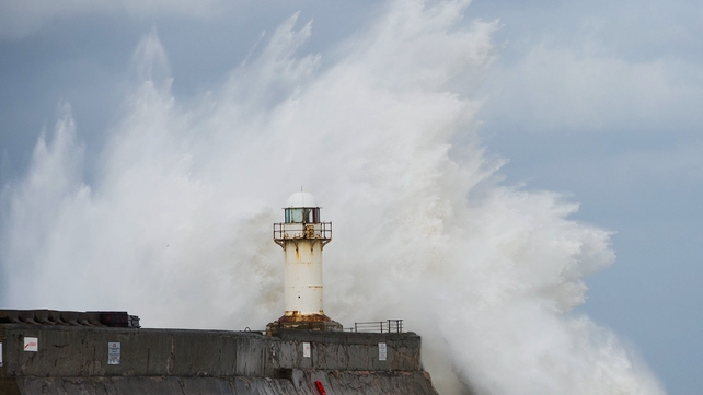 Huge waves crash against the South Gare lighthouse in South Gare, Teesside, England