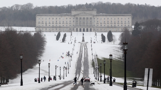 Pedestrians walk through the snow at the Stormont estate in Belfast, Northern Ireland on Saturday