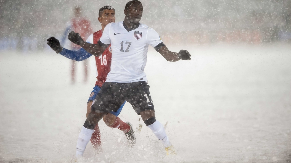 Jozy Altidore of the United States and Costa Rica's Diego Calvo battle for possession in dire conditions in Commerce City, Colorado