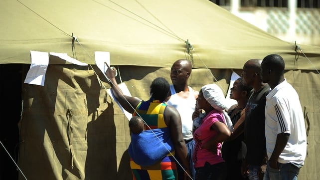 People check for results outside a polling station in Mbare township after voting for a new constitution People check for results outside a polling station in Mbare township after voting for a new constitution