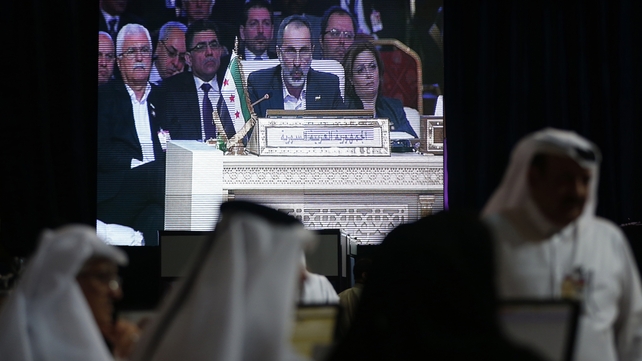 Moaz Alkhatib appears on a screen as he addresses the opening of the Arab League summit in the Qatari capital Doha Moaz Alkhatib appears on a screen as he addresses the opening of the Arab League summit in the Qatari capital Doha