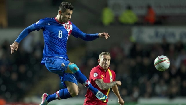 Dejan Lovren gets in ahead of Graig Bellamy