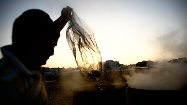 An Israeli man immerses cooking utensils into boiling water to make them kosher for the Jewish festival of Pesah (Passover) An Israeli man immerses cooking utensils into boiling water to make them kosher for the Jewish festival of Pesah (Passover)