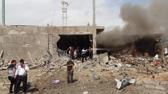 Firefighters extinguish a fire caused by a car bomb that detonated near a Shia mosque killing three people and injuring 70 others Firefighters extinguish a fire caused by a car bomb that detonated near a Shia mosque killing three people and injuring 70 others