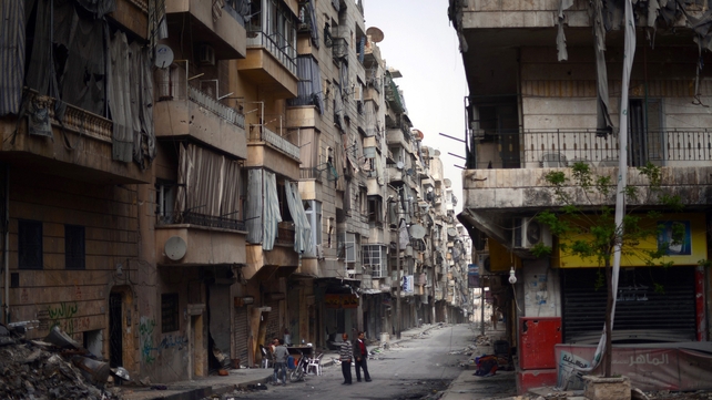 Syrian people stand in the middle of a street in the Saladin district of the northern Syrian city of Aleppo, yesterday Syrian people stand in the middle of a street in the Saladin district of the northern Syrian city of Aleppo, yesterday