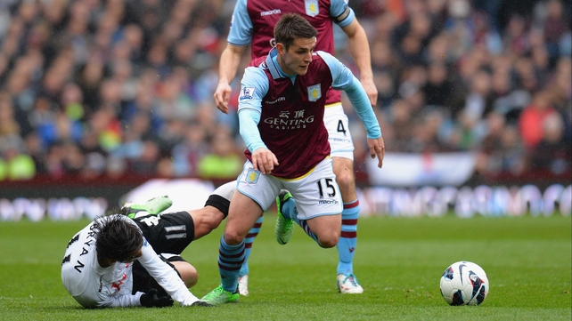 Ashley Westwood of Aston Villa breaks away from Bryan Ruiz of Fulham