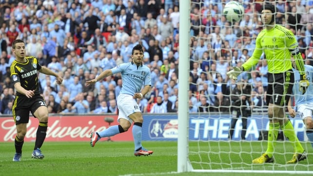 Sergio Aguero watches his header pass Petr Cech in the Chelsea goal