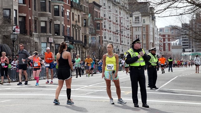 Police and runners stand in shock near Kenmore Square in Boston shortly after yesterday's attacks