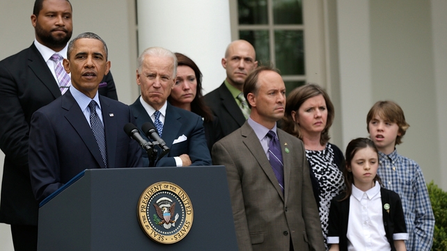 US President Barack Obama, surrounded by family members of victims of gun violence, makes a statement with Vice President Joe Biden US President Barack Obama, surrounded by family members of victims of gun violence, makes a statement with Vice President Joe Biden