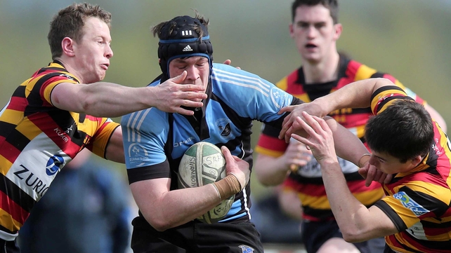 Shannon's Fergal Walsh is tackled by Matt Healy and Tom Kiersey of Lansdowne