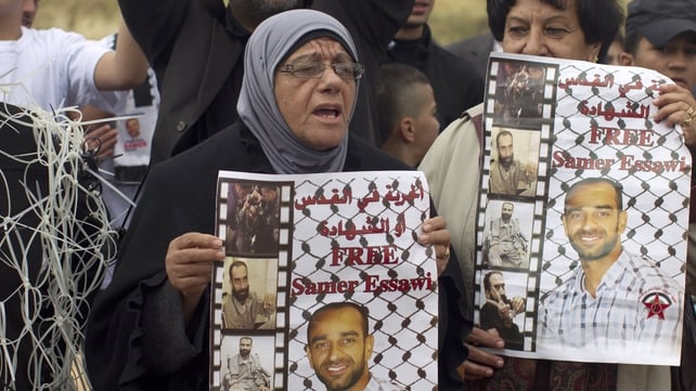 Layla Essawi, the mother of Samer Essawi, holds up his poster as she and others take part in a solidarity sit-in Layla Essawi, the mother of Samer Essawi, holds up his poster as she and others take part in a solidarity sit-in