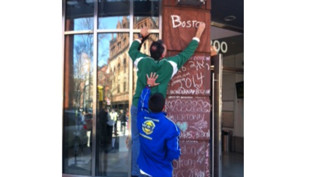 Charles Doherty writes 'Boston you're my home' at a pop up memorial in the city Charles Doherty writes 'Boston you're my home' at a pop up memorial in the city