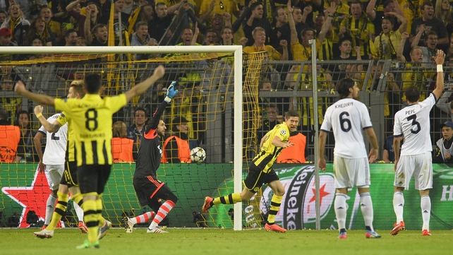 Borussia Dortmund's Robert Lewandowski wheels away after scoring the third of his four goals