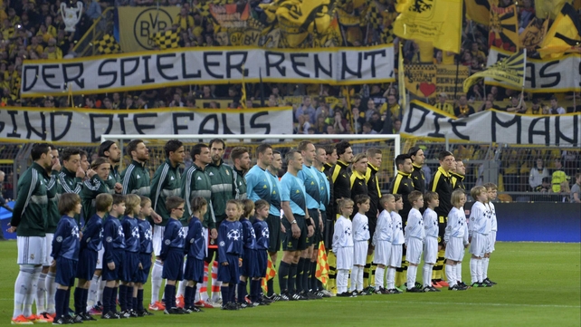 Borussia Dortmund and Real Madrid players line up ahead of the match