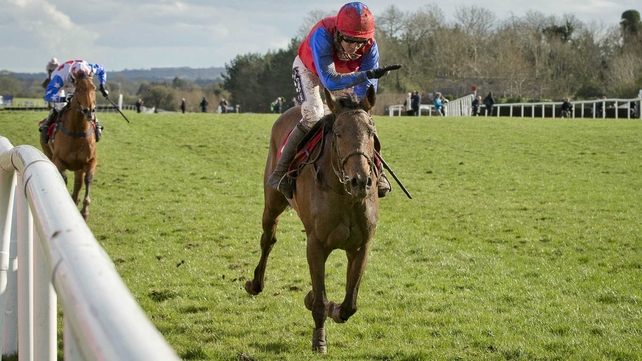 Ruby Walsh gives a muddy Quevega a congratulatory slap as she wins the feature on the third day of the Punchestown Festival