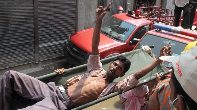 A Bangladeshi survivor reacts after he was recovered, 60 hours after the collapse A Bangladeshi survivor reacts after he was recovered, 60 hours after the collapse