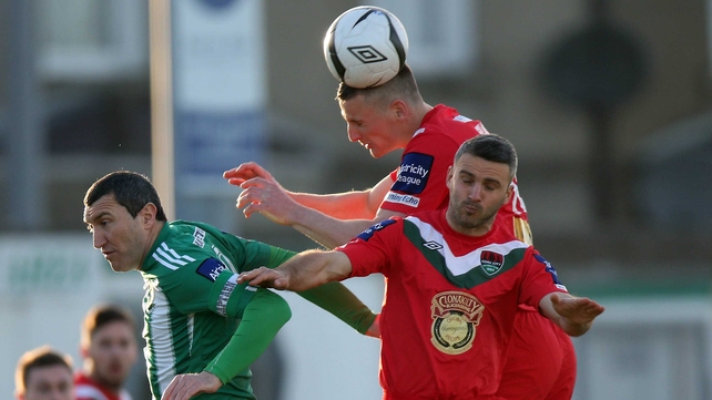 Jason Byrne of Bray with Danny Murphy and Kalen Spillane of Cork