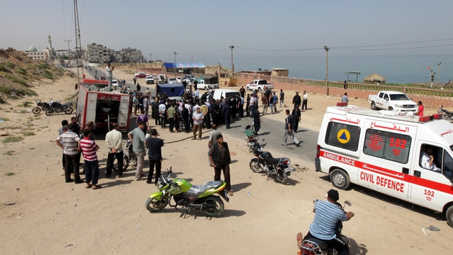 Palestinians gather around the scene following the Israeli raid Palestinians gather around the scene following the Israeli raid