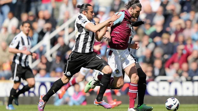 West Ham's Andy Carroll tries to escape the attention of Jonaz Gutierrez
