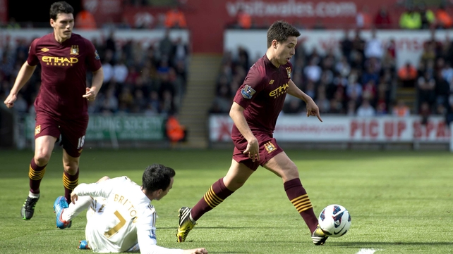 Man City's Samir Nasri races past the challenge of Leon Britton