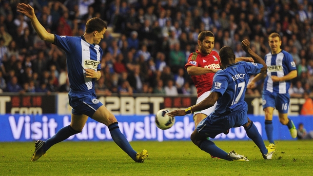 Itay Shechter hits Swansea City's equaliser as Gary Caldwell and Emmerson Boyce attempt to block the shot