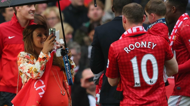 Wayne Rooney has his picture taken by his wife Coleen following the Barclays Premier League match between Manchester United and Swansea