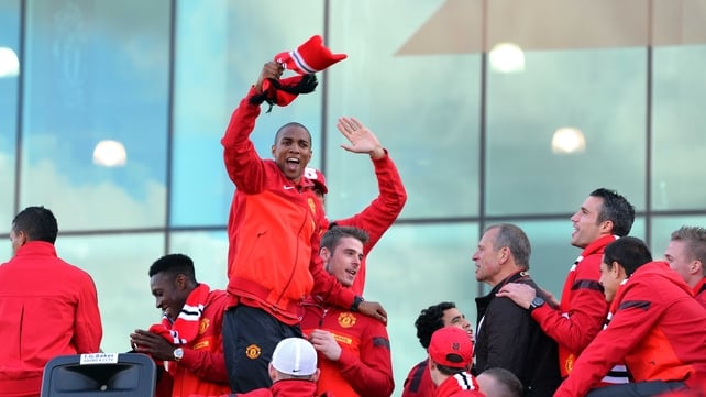 Manchester United players celebrate on an open top bus