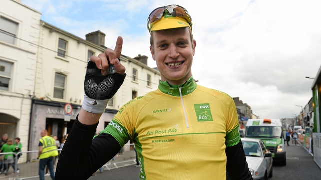 Conor Dunne celebrates taking the yellow jersey.