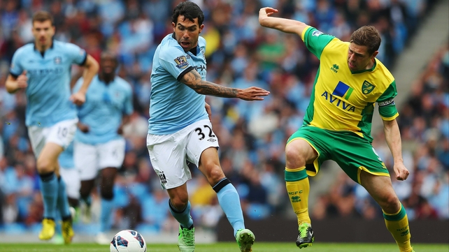 Carlos Tevez protects the balls from Grant Holt