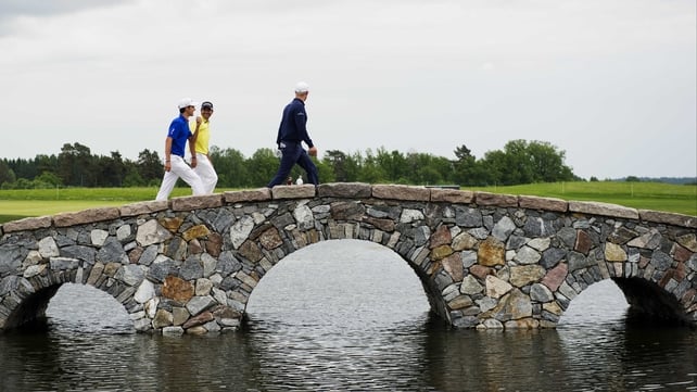 Italy's Matteo Manassero (l) and and Finland's Mikko Ilonen (r) walk to the third hole